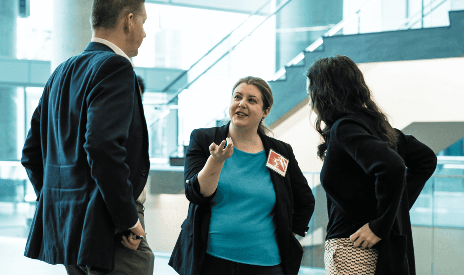 Dr. Cecelia Costiniuk in conversation at a conference. 