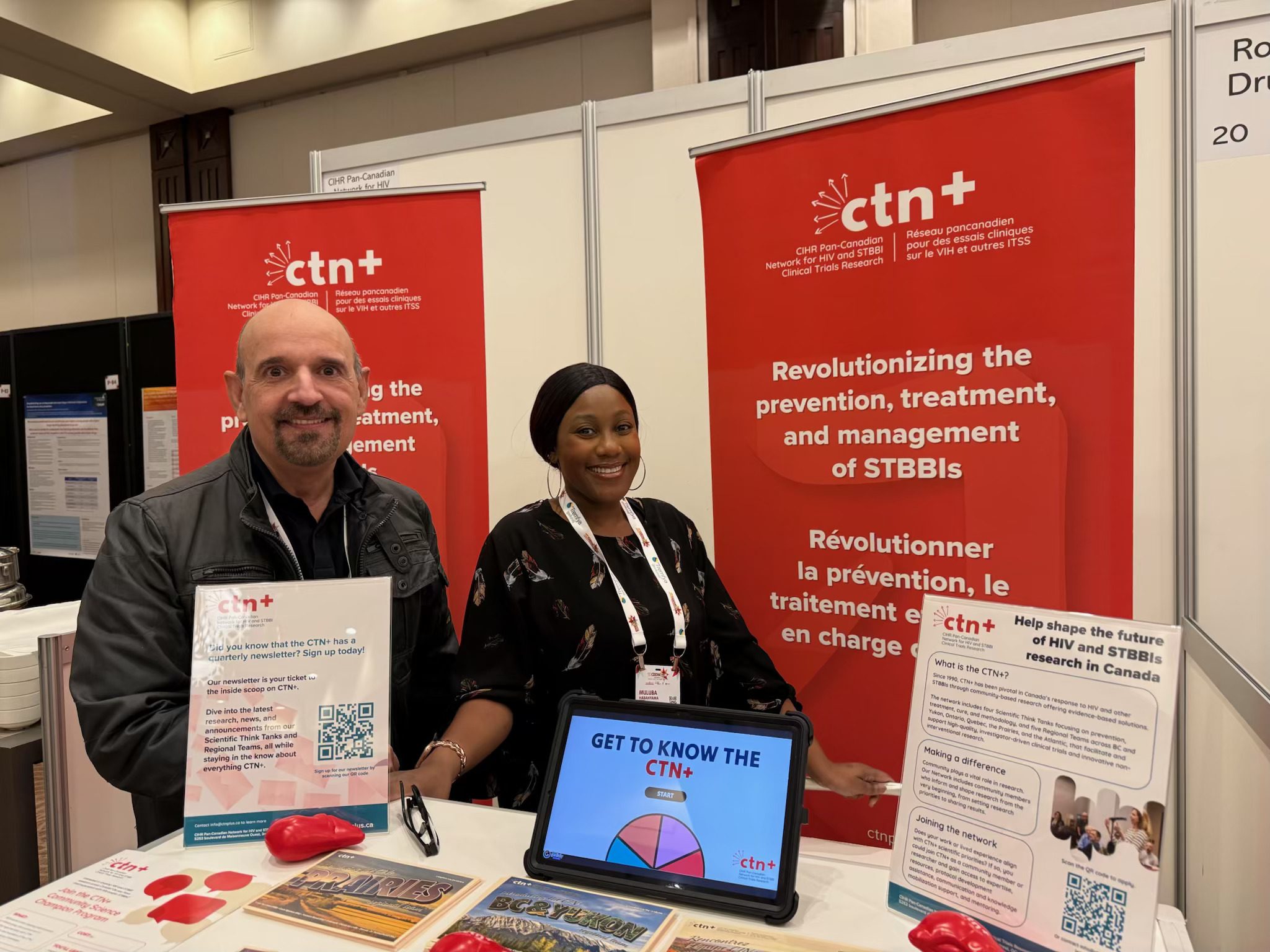 Enrico Mandarino and 
Muluba Habanyama at a CTN+ conference booth. 